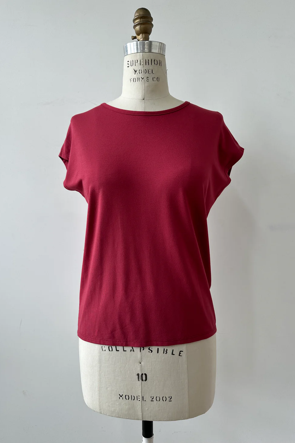 The Eowyn T-Shirt by Kollontai in Raspberry is shown on white mannequin against a white background