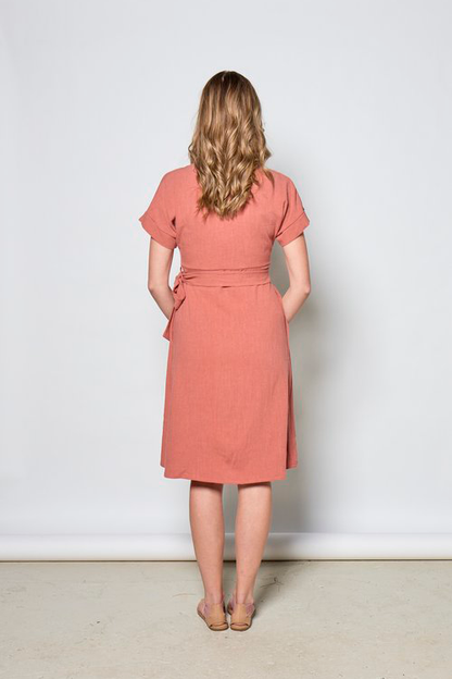 Maura Dress by Tangente, Coral, back view, wrap dress, V-neck, short cuffed sleeves, attached tie belt, above the knee, hidden side pockets, eco-fabric, OEKO-TEX certified, viscose/linen, sizes XS to XXL, made in Ottawa 