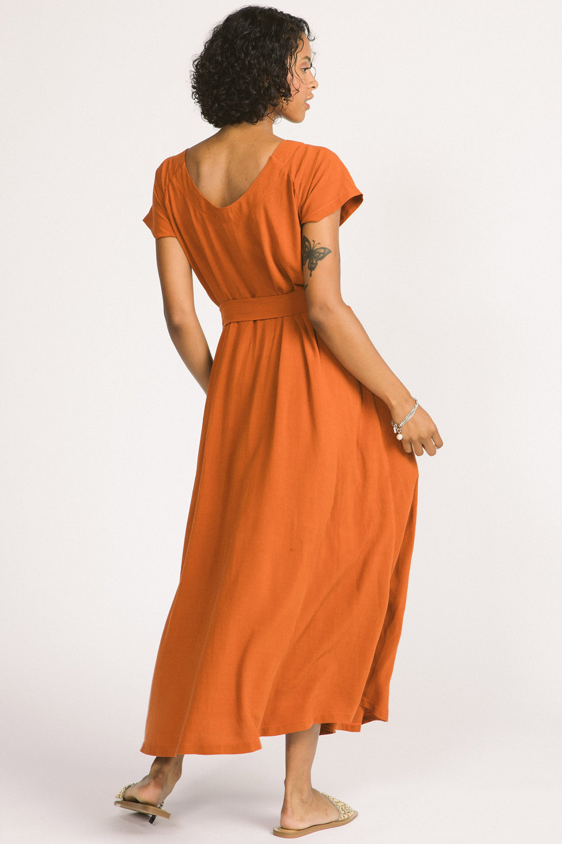 Enola Dress by Allison Wonderland, Rust, back view, voluminous maxi dress, scoop neck front and back, short raglan sleeves, front horizontal seam with gathers below the natural waist, pockets, matching belt, eco-fabric, viscose, linen, sizes 2-12, made in Vancouver