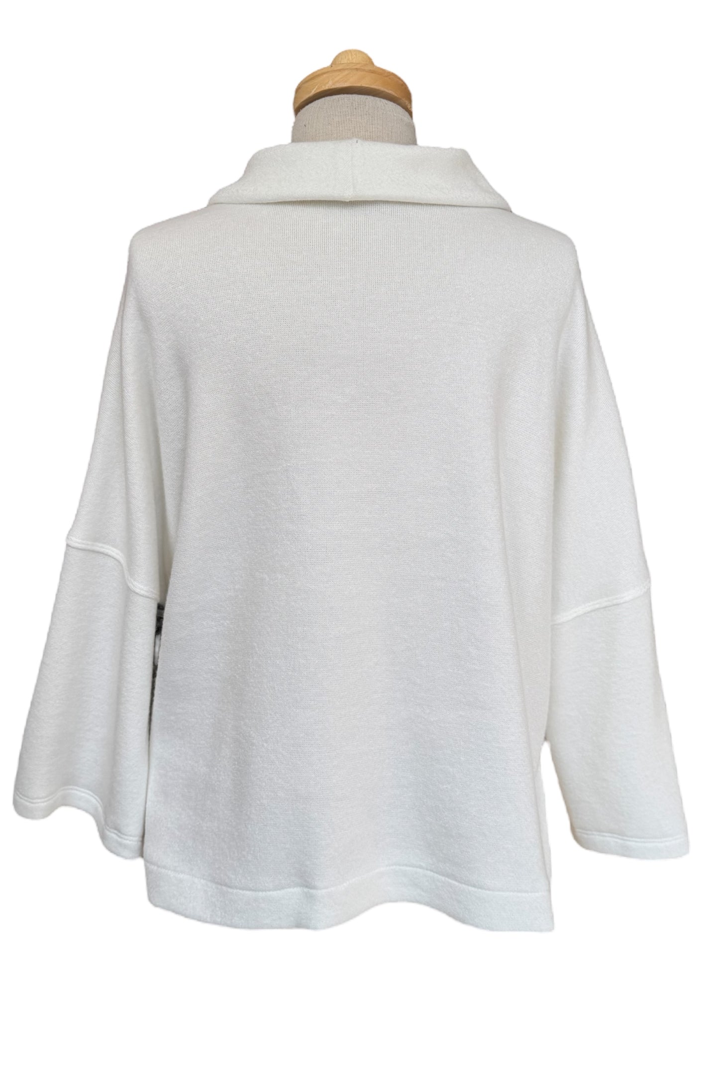 A back view of the Paige Sweater by Compli K in Off-White, featuring a large cowl neck, drop-sleeves, a loose fit, and side slits, is shown on a mannequin against a white background.