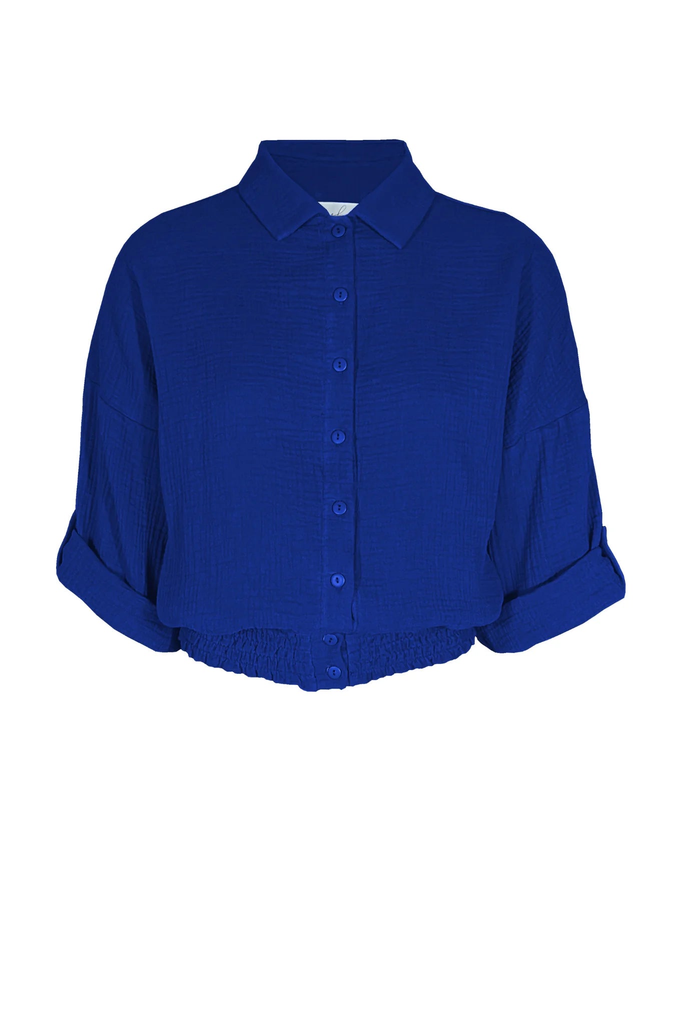 The Kemet Shirt by Melow in Cobalt, featuring a blouse collar, button front, honeycomb elastic waist, and cropped sleeves that fold and fasten with a button tab, is shown against a white background.