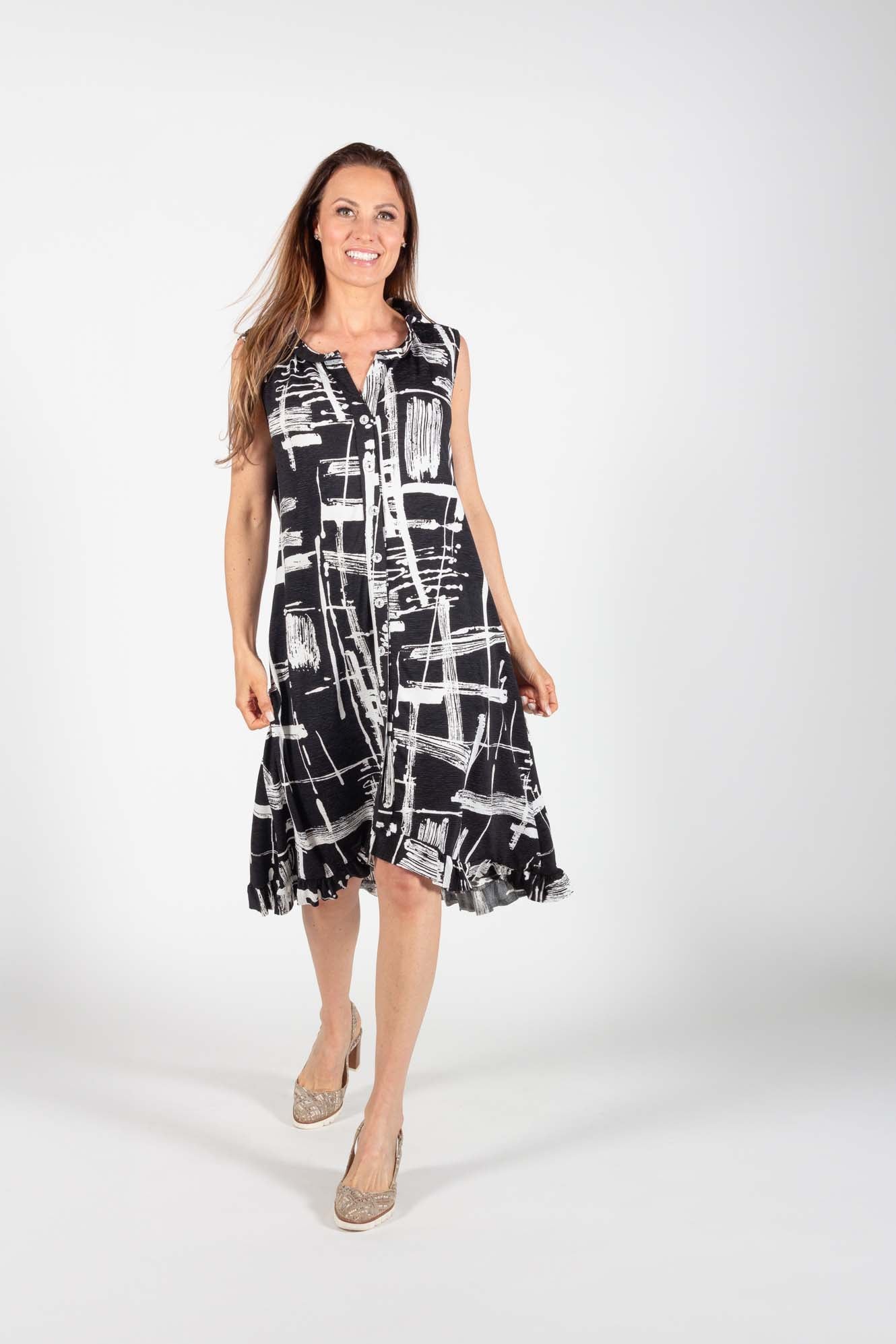 A woman wearing the Cordelia Dress by Pure Essence in Black/White Print standing in front of a white background