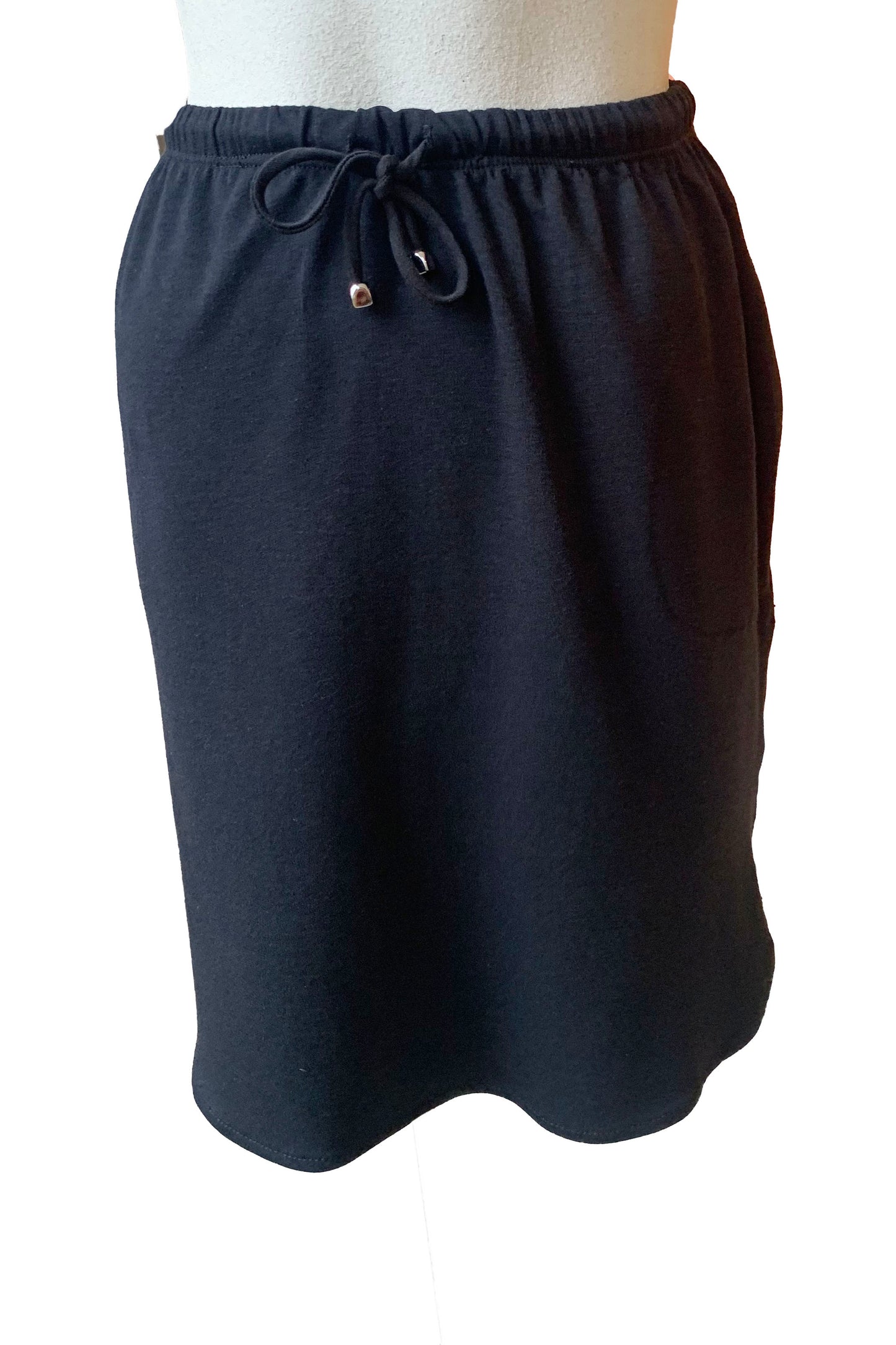 Casey Skirt by Pure Essence, Black, elastic waist with drawstring, side pockets, above the knee length, rounded hem is higher at the sides, eco-fabric, bamboo and cotton, sizes XS to XXL, made in Canada