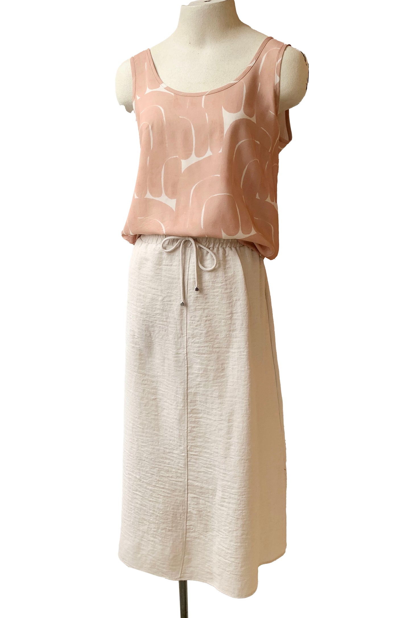The Cole Skirt in Sand by Pure Essence is shown with the Isatis Top by Cokluch on a mannequin in front of a white background