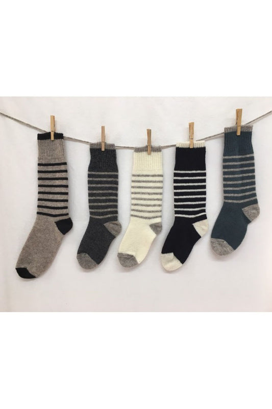 Knited Wool Socks by Charlevoix Pure Laine are shown hanging on a clothesline against a white background