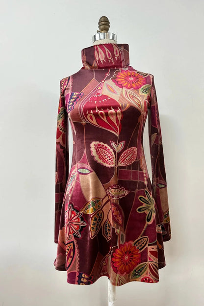  Holly Tunic by Kollontai, with a Purple print, high neck, long sleeves and A-line shape, is shown a mannequin.