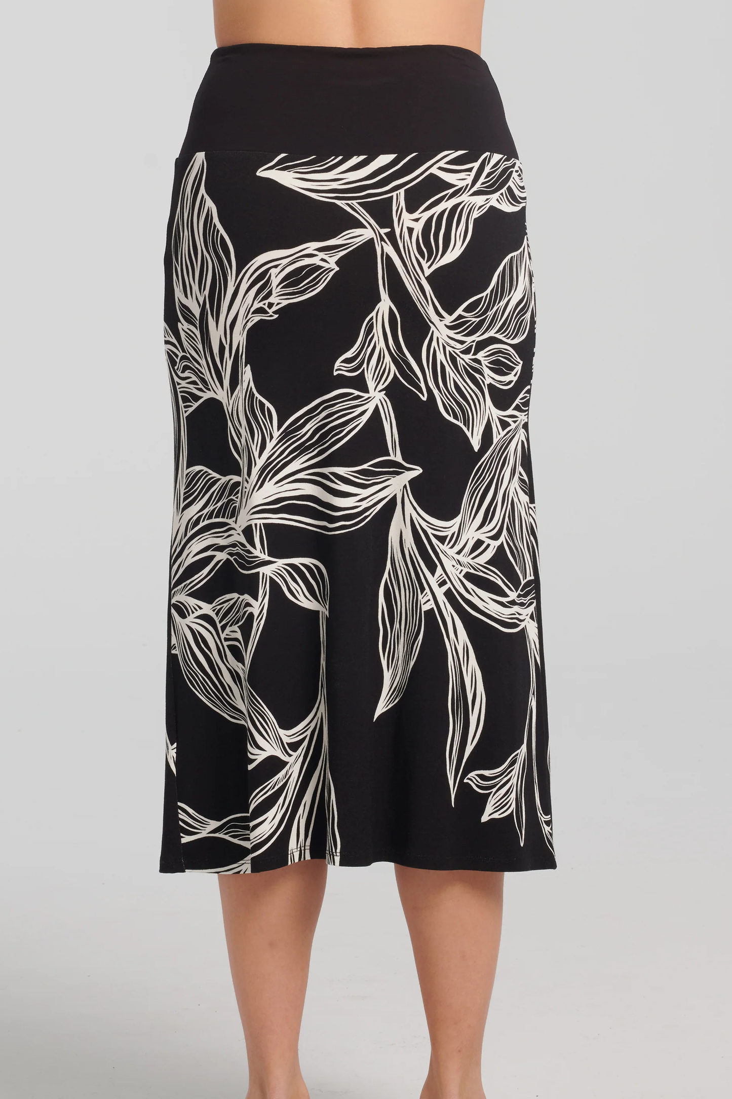 Ostara Skirt by Kollontai, Black and white leaf print, back view, solid black pull-on waistband, mid-calf length, slight A-line shape, sizes XS to XXL, made in Montreal 