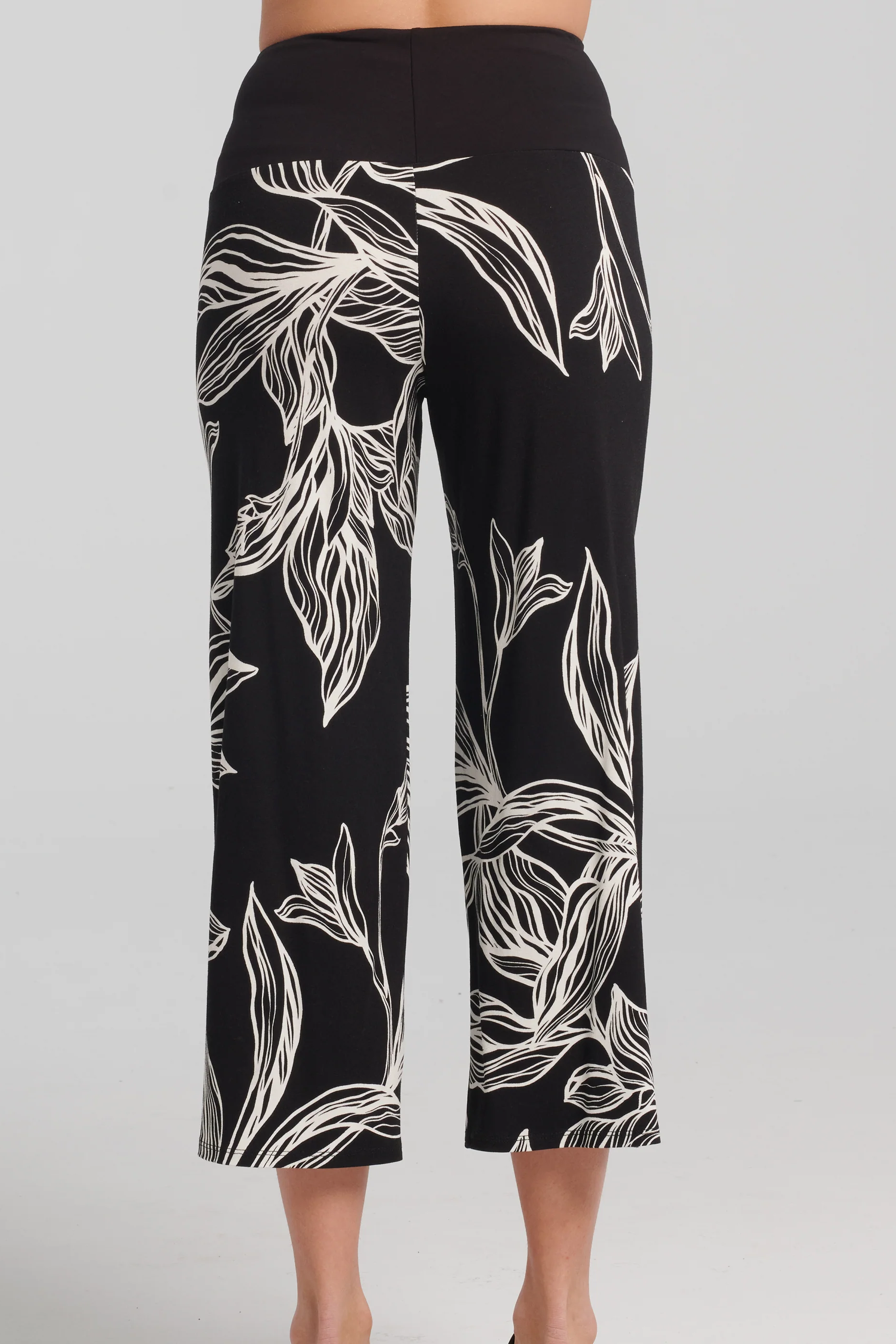 Thora Pants by Kollontai, Black and white leaf print, back view, solid black pull-on waistband, wide legs, slightly cropped, sizes XS to XXL, made in Montreal