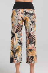 Selket Pants by Kollontai, back view, neutral tropical print on legs, wide pull-on black waistband, wide legs, cropped length, sizes XS to XXL, made in Quebec