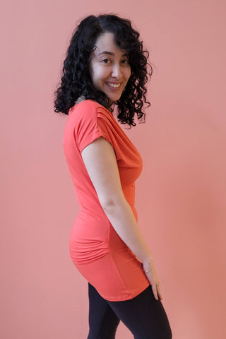 Gentianne Top by Melow, Coral, side view, pleats at shoulder and hip, short extended sleeves, hem can be pulled up or down, eco-fabric, bamboo-rayon, OEKO-TEX certified, sizes XS to L, made in Montreal
