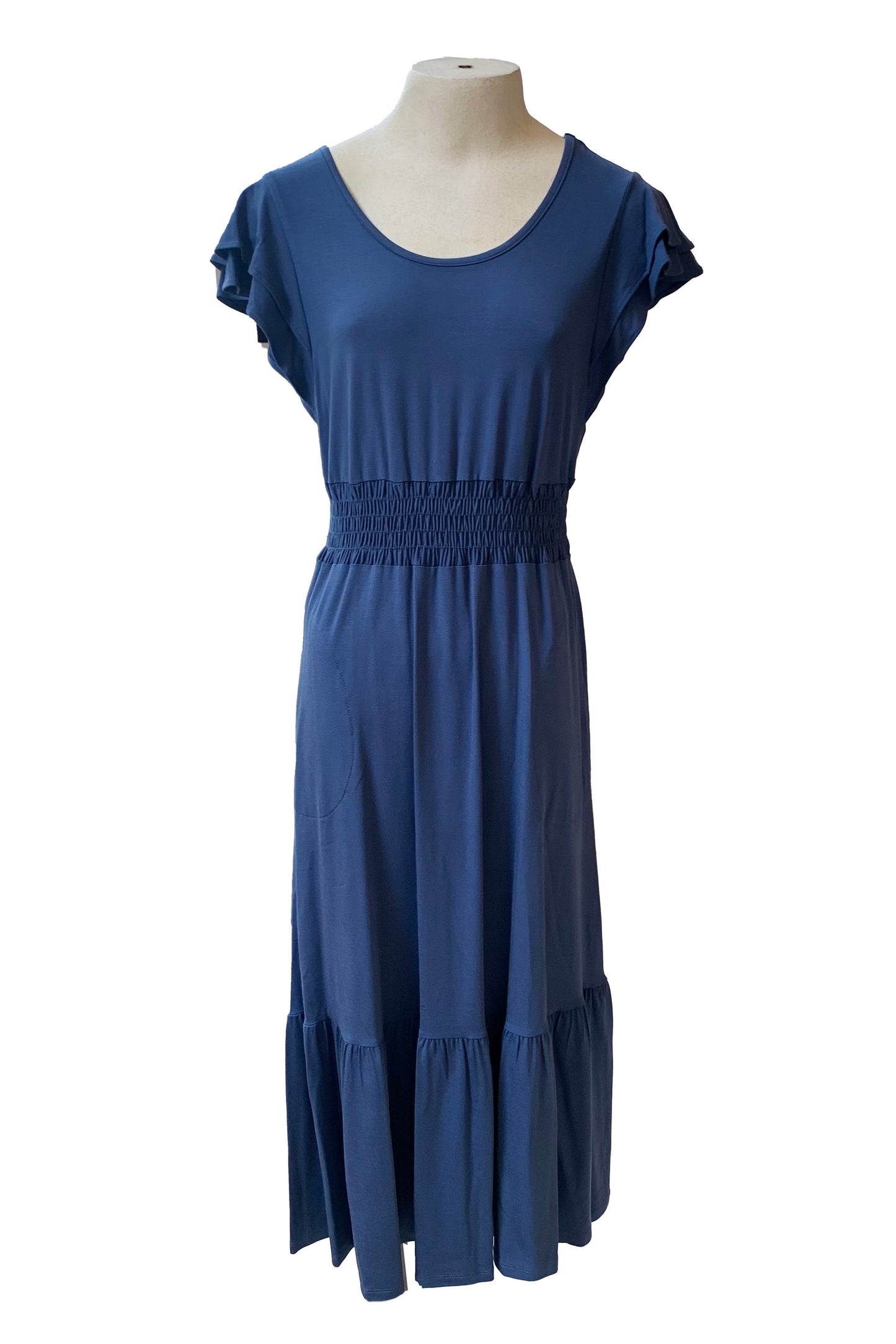 The Cherlyn Dress by Pure Essence in Navy is shown on a mannequin in front of a white background 