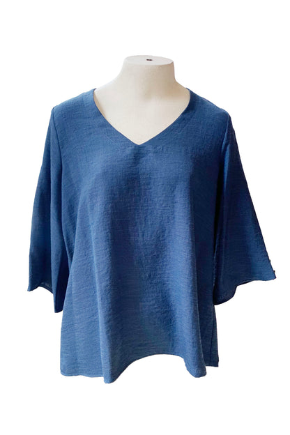 The Calypso Top by Pure Essence in Indigo is show on a mannequin in front of a white background 