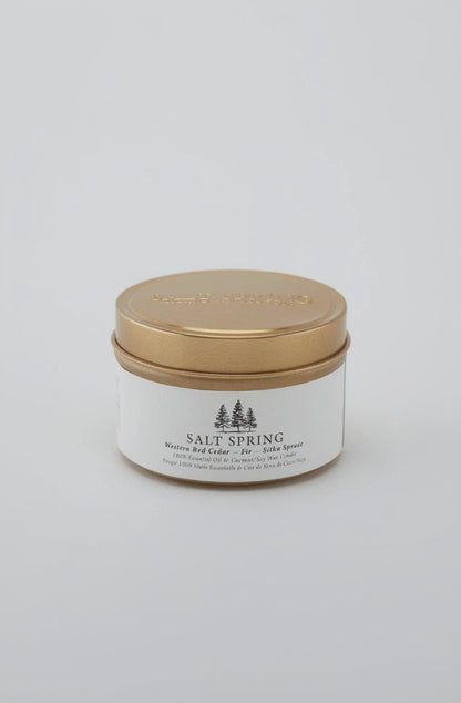 Candle jar with gold lid and 'Salt Spring' label on a light gray background