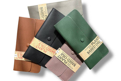 Four textured leather wallets from Armoir are arranged diagonally on a white background. 