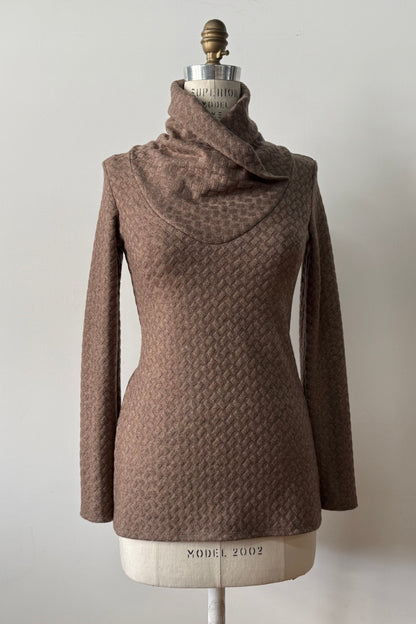 The Eloi Sweater by Kollontai in Brown, a slim fitting textured sweater with a large crossover collar, is shown on a mannequin against a white background. 