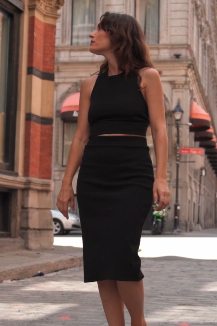 Semi close-up of a woman wearing the Cartagena Skirt by MAS in Pepper, standing on a cobblestone street
