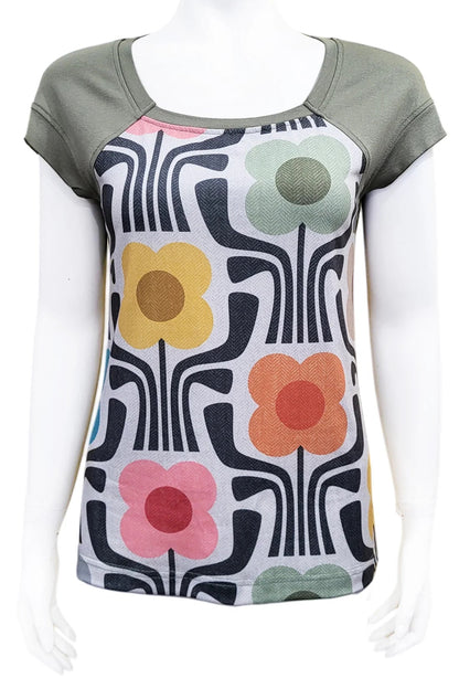 The Decades Era Tee by Mandala in 70s Kitsch, featuring a print with large stylized flowers grey shoulders and back, is shown on a mannequin in front of a white background. 