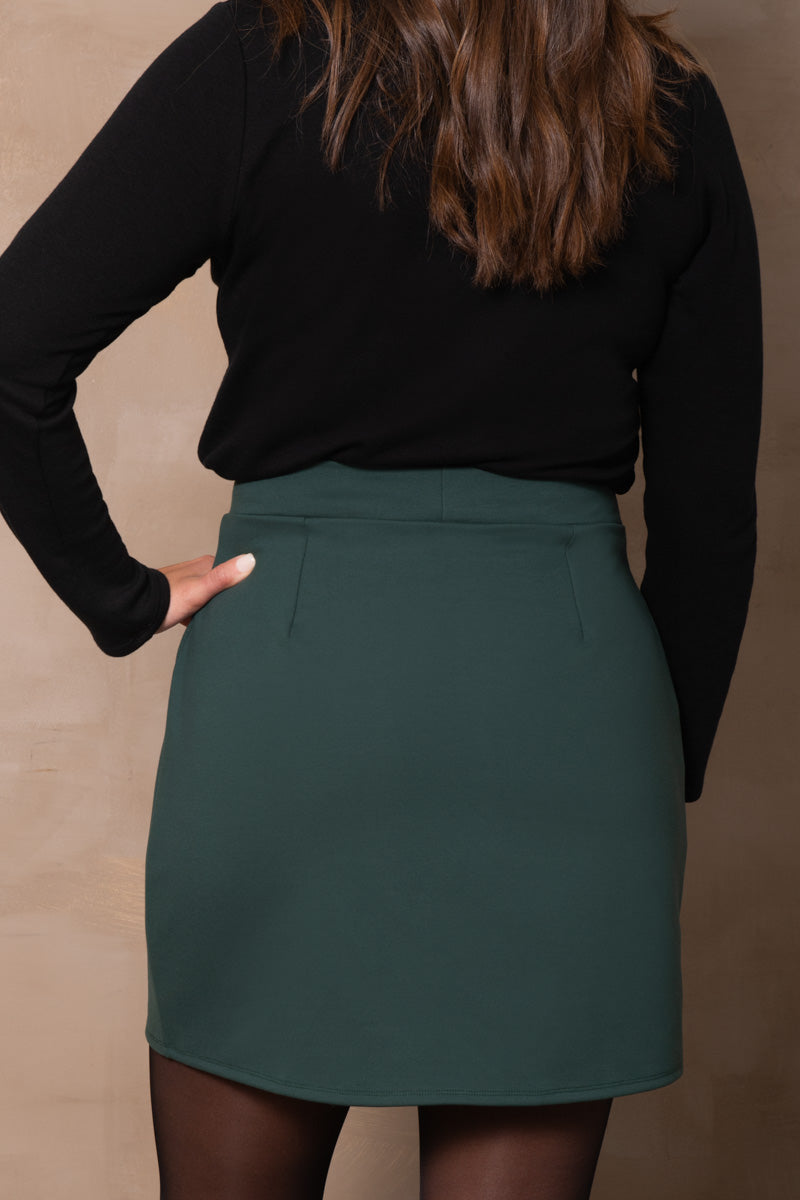 Antigone Skirt by Cherry Bobin, Green, back view, straight cut, mid-thigh length, darts, stretchy waistband, eco-fabric, LENZING ECOVERO viscose, sizes XS to 3XL, made in Montreal
