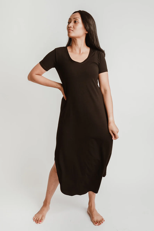 A woman wearing the Field Dress by Blondie Apparel in Black, standing in front of a white background