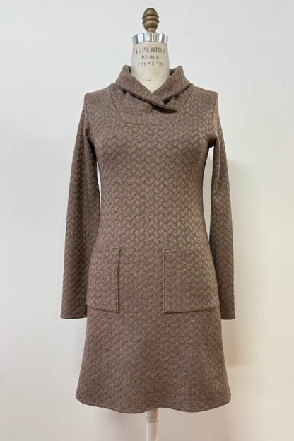 The Sacha Tunic by Kollontai in Brown, a textured knit straight cut tunic with a funnel collar and large patch pockets, is shown on a mannequin against a white background. 