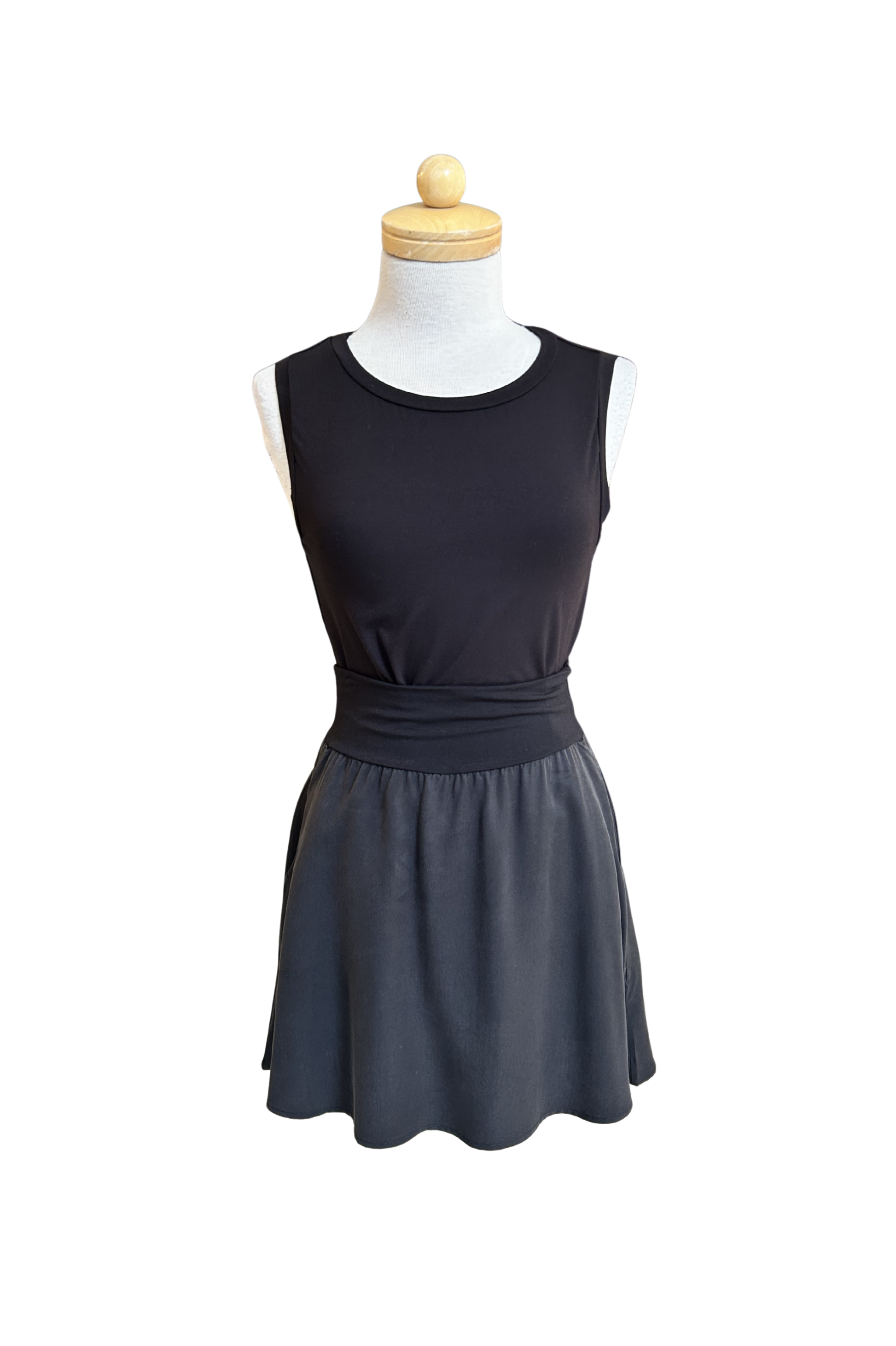 The Neon Camisole by Slak in Black, a high necked, wide strapped tank, is shown on a mannequin with a black skirt against a white background.