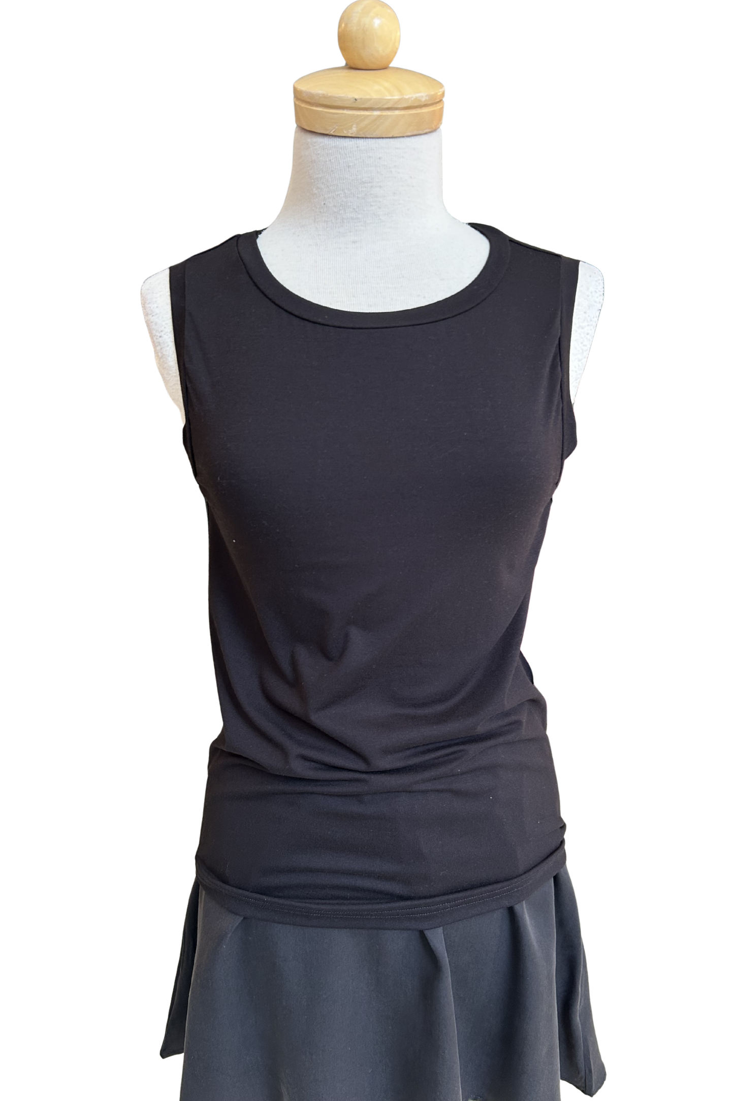 he Neon Camisole by Slak in Black, a high necked, wide strapped tank, is shown on a mannequin with a black skirt against a white background.