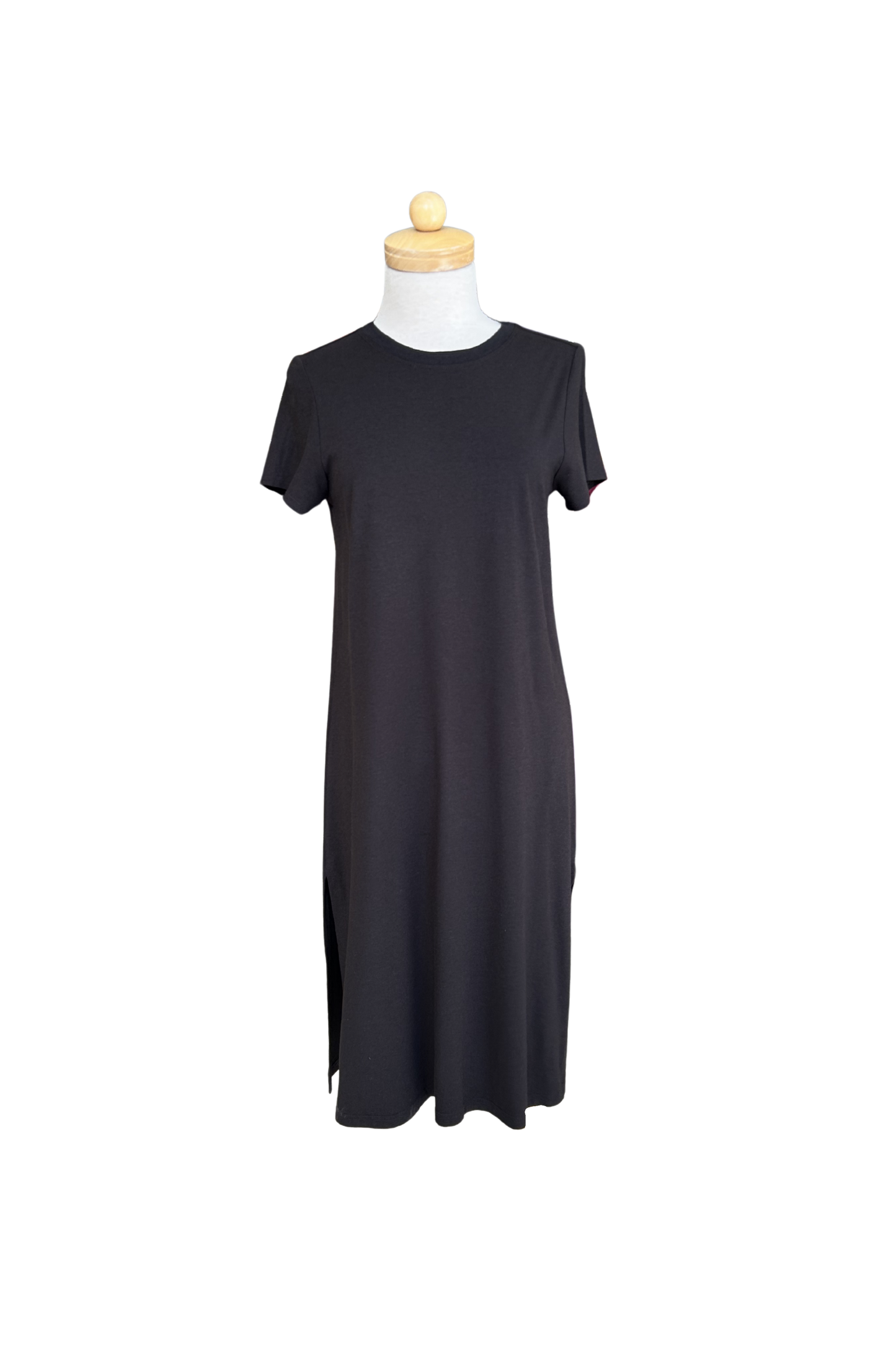 The Frances Midi  by Tangente in Black, a short sleeved loose fitting dress with side slits, is shown on a mannequin against a white background. 