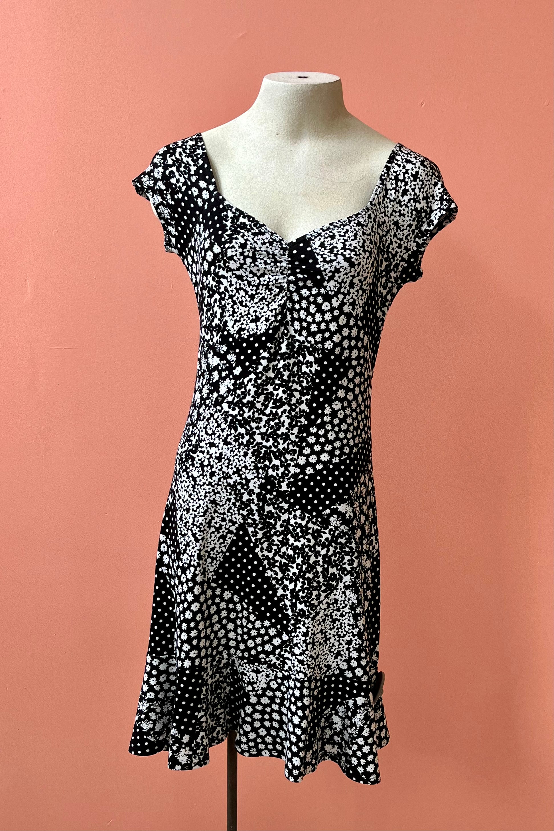 Lolita Dress by Luc Fontaine, black and white floral patchwork print, sweetheart neckline, cap sleees, fit and flare shape, ruffled hem, sizes 4-16, made in Montreal