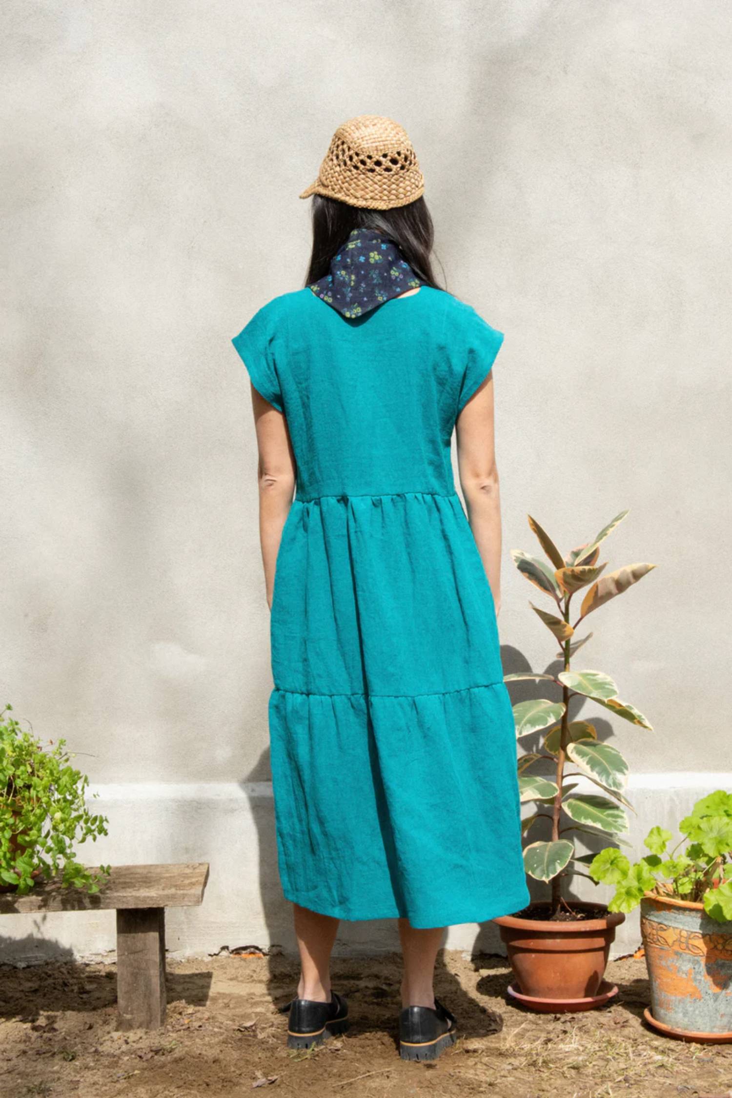 Aster Dress by Kazak, Turquoise, back view, midi-length, tiered skirt, loose fit, square neckline, short extended sleeves, eco-fabric, linen, OEKO-TEX certified, sizes XS to XL, made in Montreal