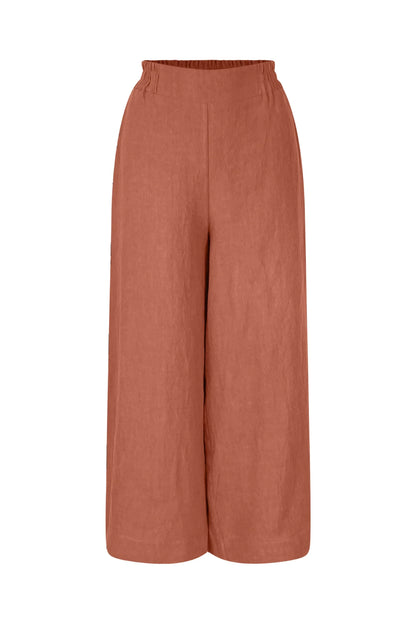 The Marlot Pants by Meow in Rosewood, wide-legged cropped linen pants with a pull on elastic waistband that's smooth at the front, are shown against a white background. 
