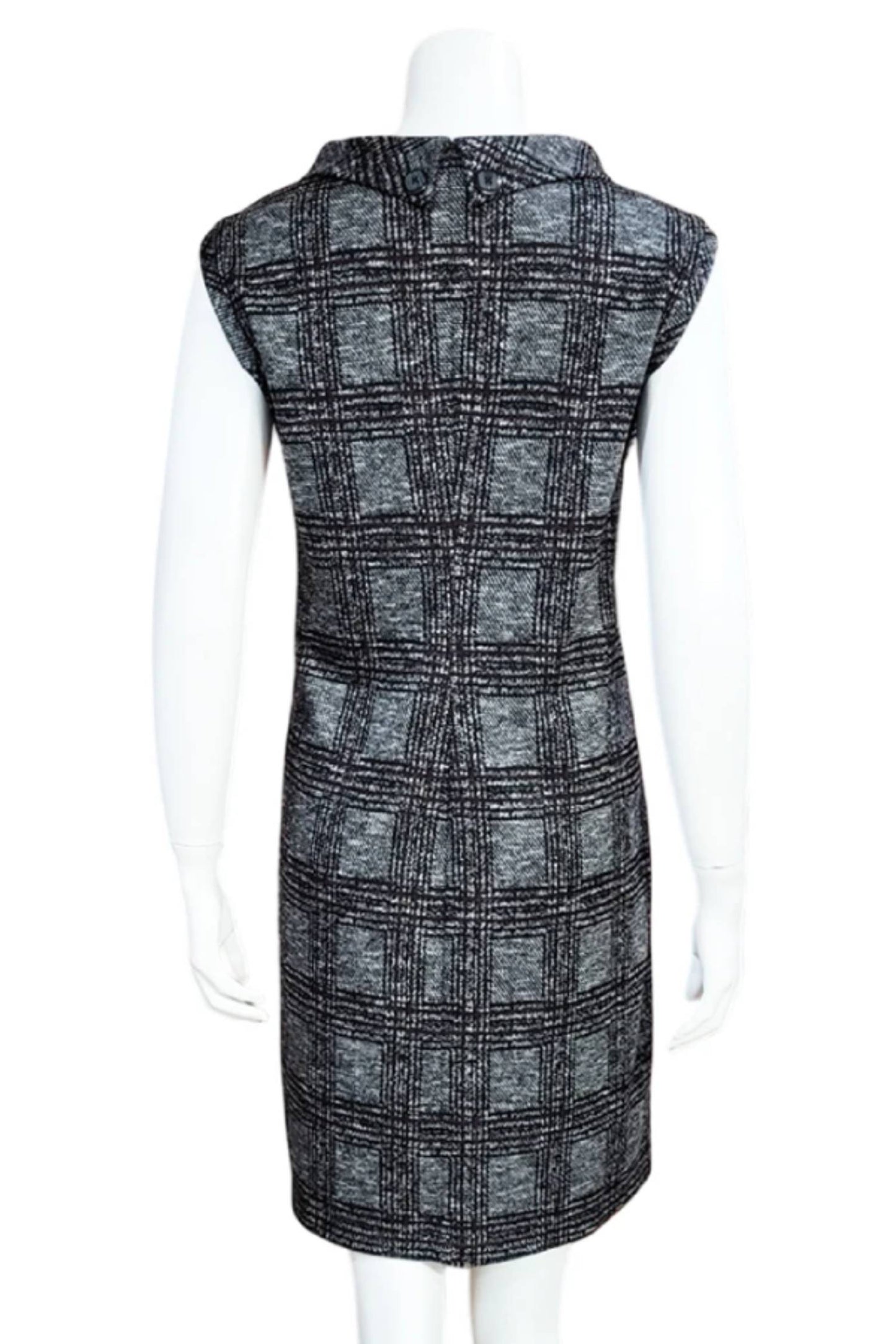 A back view of the Harris Check Tunic by Mandala in Green, a sleeveless tweed tunic with a roll collar and French darts, is shown on a mannequin against a white background. 