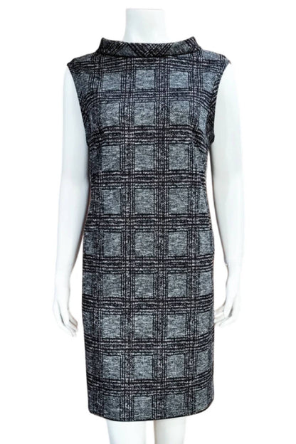 The Harris Check Tunic by Mandala in Green, a sleeveless tweed tunic with a roll collar and French darts, is shown on a mannequin against a white background. 