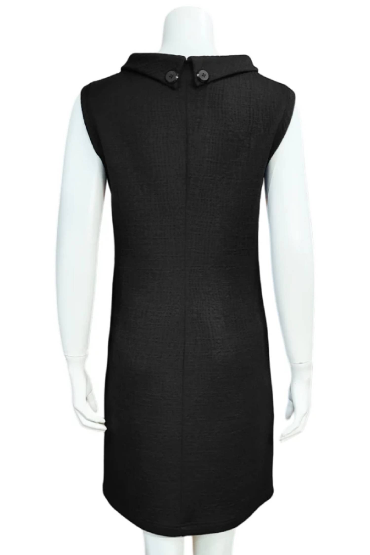 A back view of Mandala's Linus Jacquard Tunic in Black, a sleeveless piece featuring a roll collar, French darts, and pockets, is shown on a mannequin against a white background. 