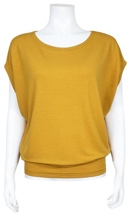 The Mandala Charlie Slouch Tee in Harvest Gold, with a round neck, short extended sleeves, and a fitted hem, is shown on a mannequin against a white background. 