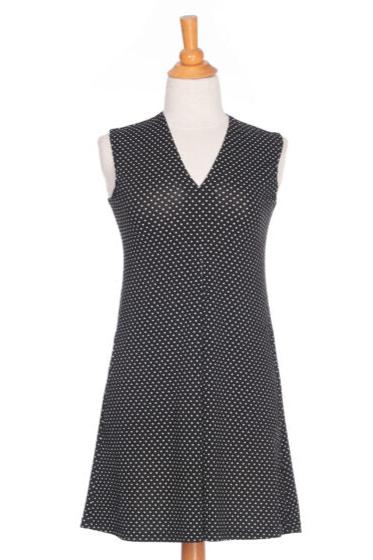 The Samba Dress by Rien ne se Perd in Black and White Polka Dot, a sleeveless short dress with a V-neck, centre pleat, and side pockets, is shown on a mannequin in front of a white background. 