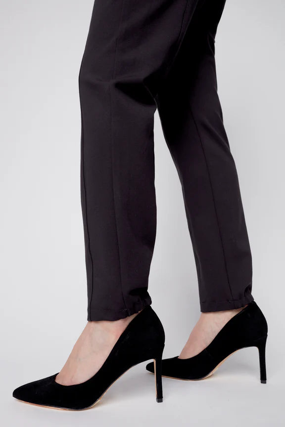 Close up lower leg view of a woman wearing the Sarah Cigarette Pant by Julei in Black, featuring four way stretch fabric, pin tucks for shape, and a pull-on waist. 