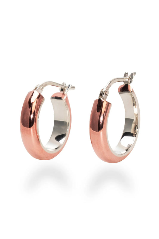 The Claudine Moncion Stack03 hoop earrings in sterling silver and copper are shown on a white background. 