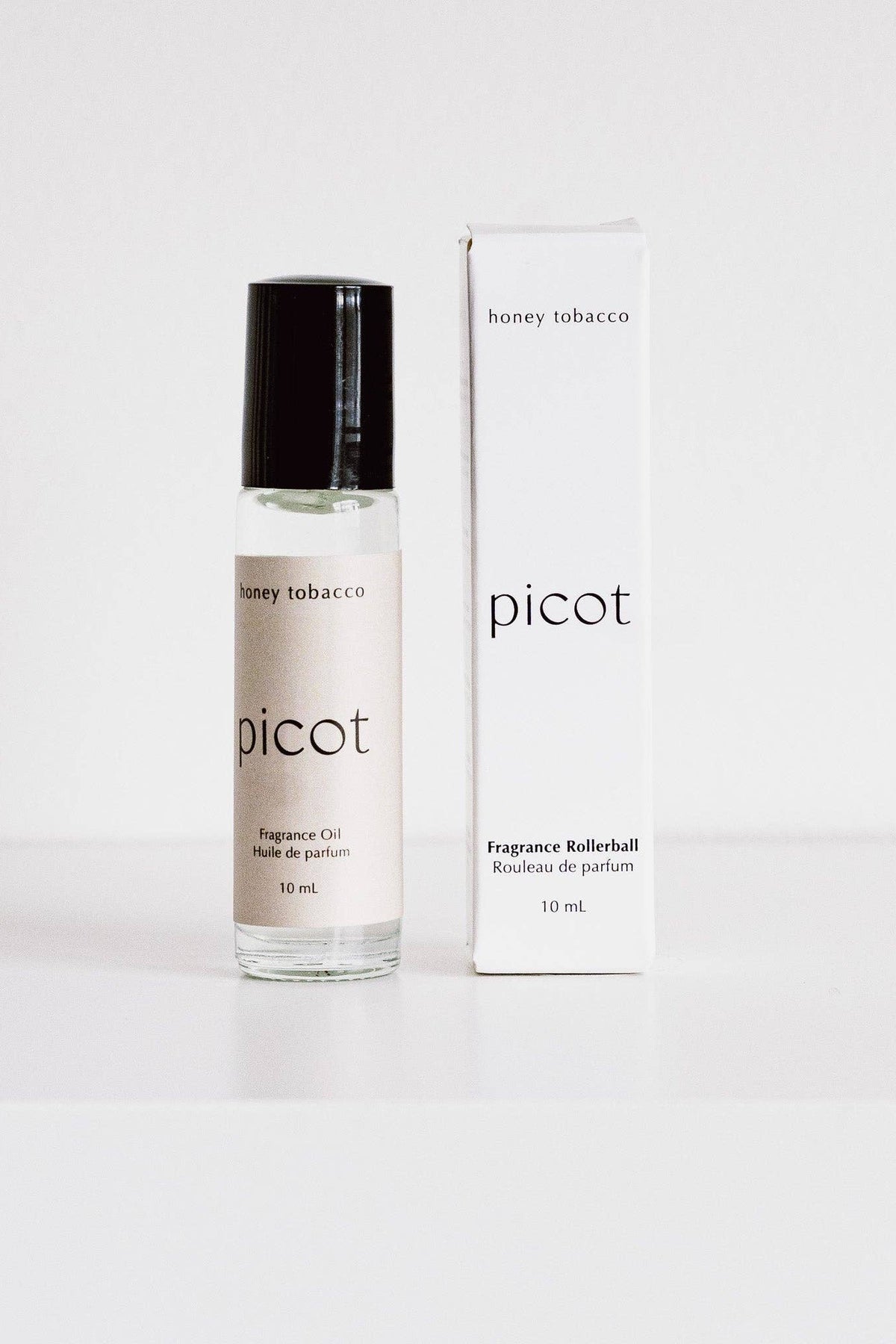 Picot Honey Tobacco fragrance rollerball with packaging on a white background