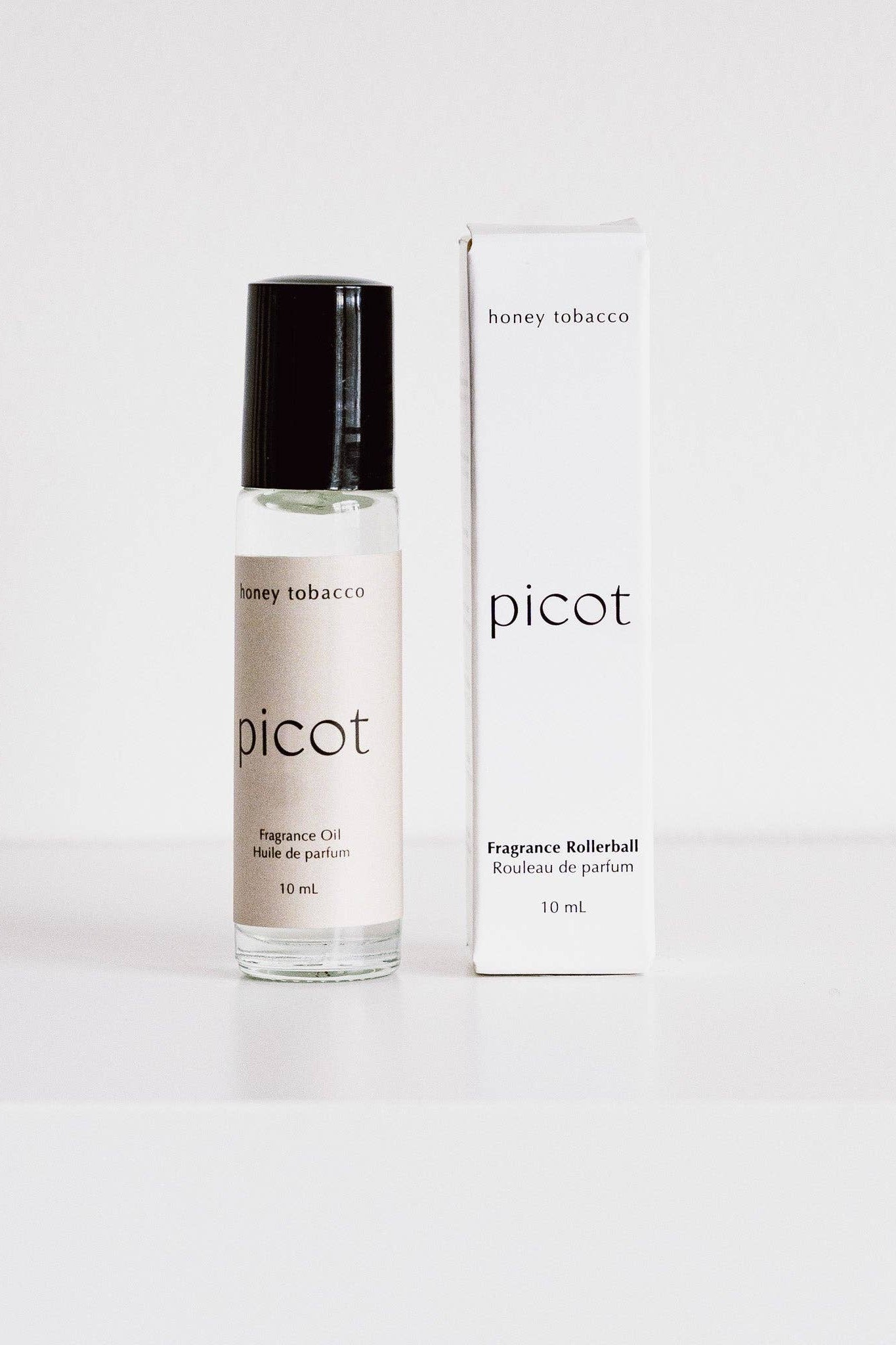 Picot Honey Tobacco fragrance rollerball with packaging on a white background