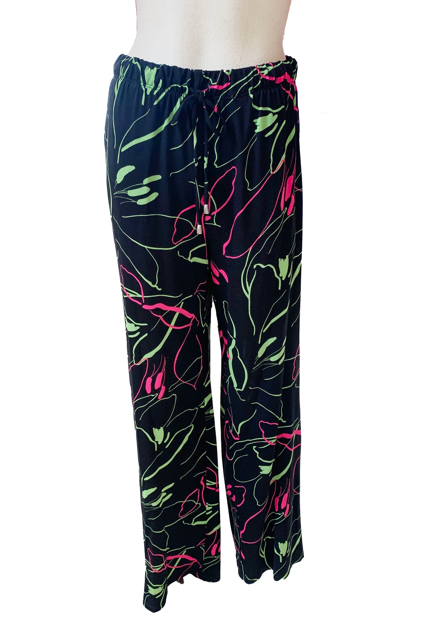 The Clarisse Pants by Pure Essence in Black/Pink/Green are shown on a mannequin in front of a white background