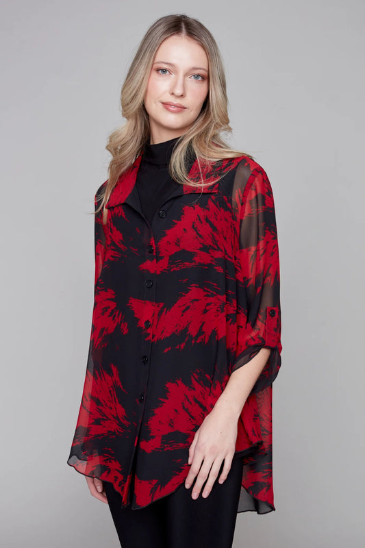 A woman wearing the Natalia Woven Blouse by Compli K in Black and Red, a sheer blouse with a collar, button front, 3/4 sleeves with a tab and button detail, and a rounded hem.