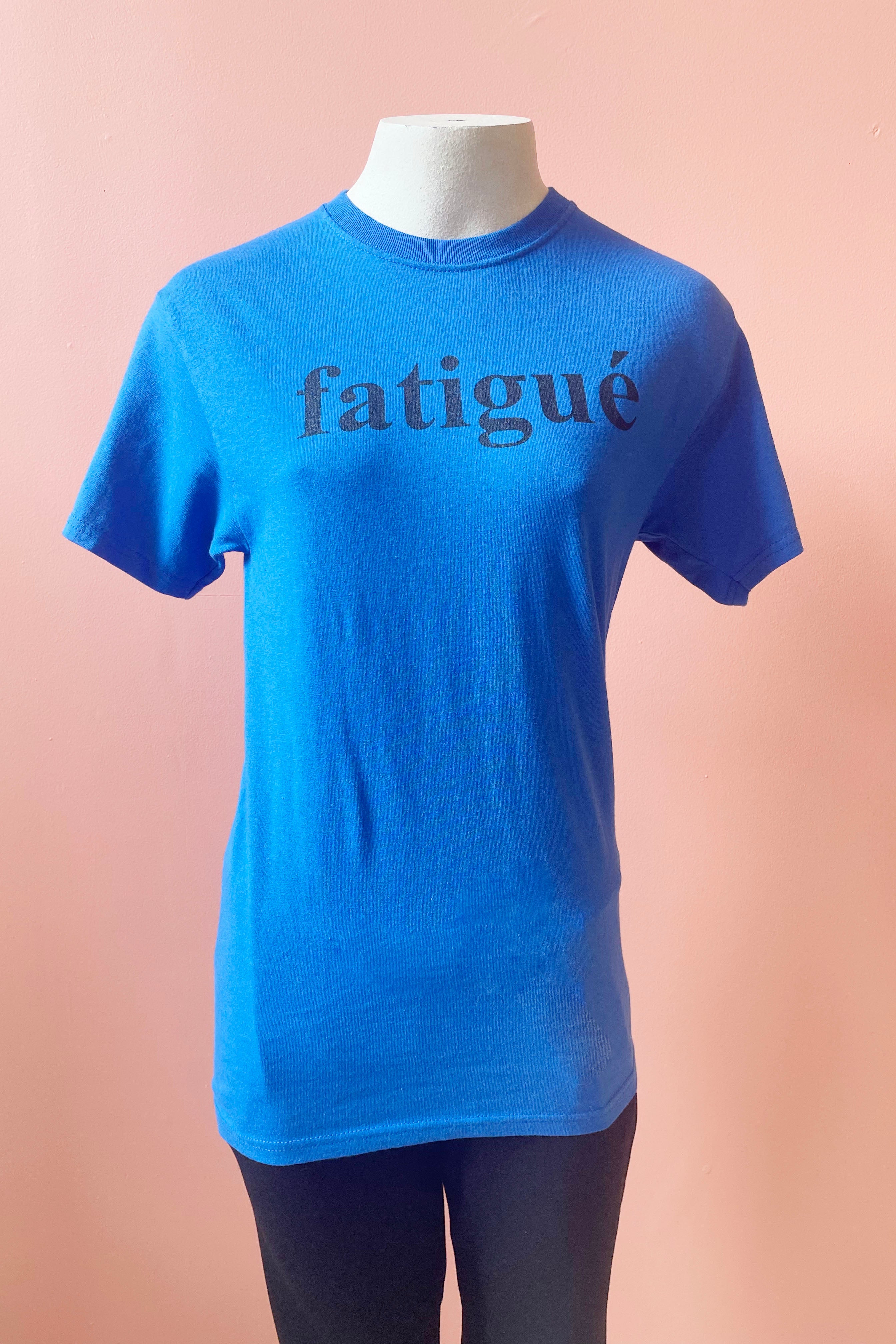 Fatigue Tee by Sara Duke, Blue, classic t-shirt with the word Fatigue printed on the front, 100% cotton, sizes S to XL, made in Toronto