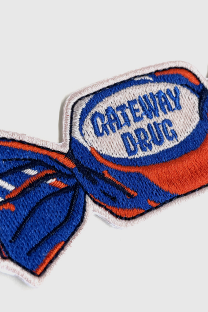 Embroidered Badaboöm Studio patch of a candy with 'Gateway Drug' text on a white background