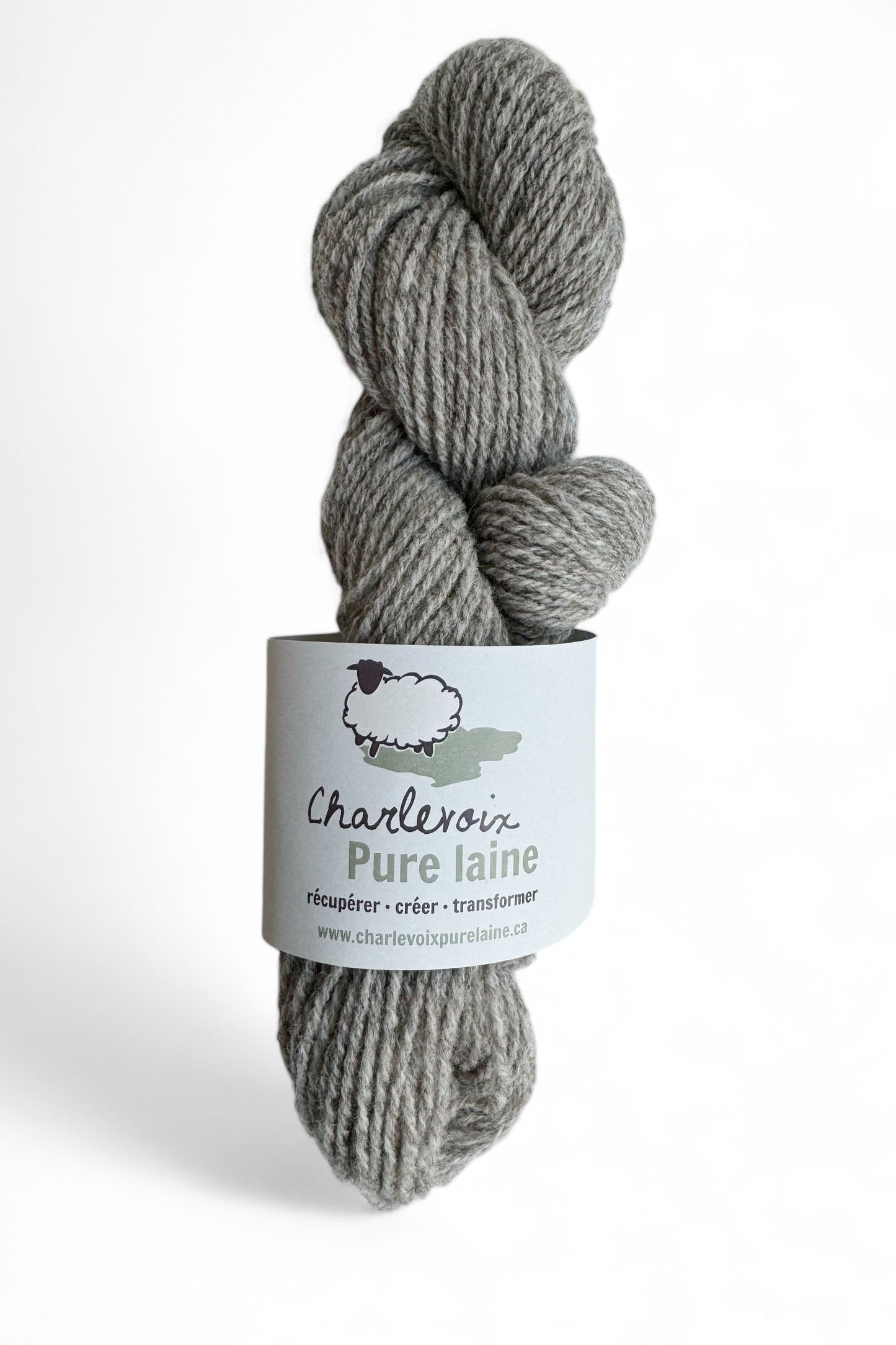 A skein of Grey yarn from Charlevoix Pure Laine is shown against a white background 