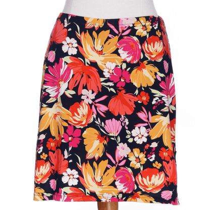 The Cocktail Skort by Rien ne se Perd in Red/Orange floral print, an elastic waist miniskirt with built-in matching bike shorts, is shown on a mannequin against a white background.