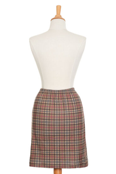 A back view of The Rosa Skirt by Rien ne se Perd in Plaid is show on a mannequin in front of a white background