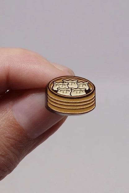 Person's hand holding a Dumpling Earring by Lilipop 