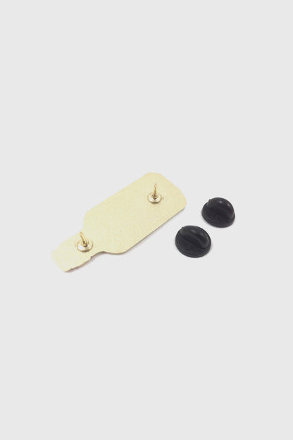 A back view of the Mermaid in a Bottle Pin from Badaboöm Studio is shown against a white background. 