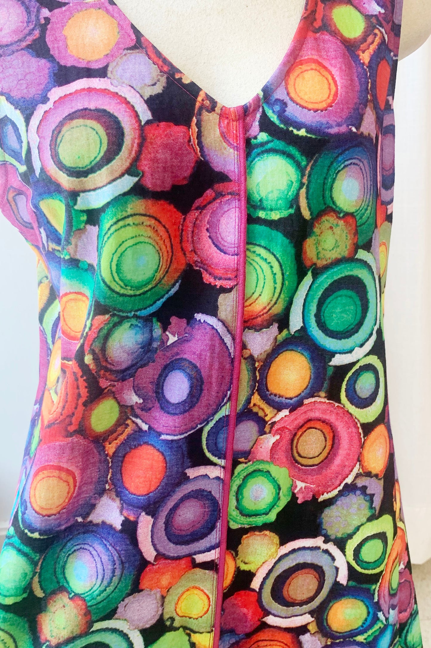 Close-up of the Camryn Dress by Pure Essence, featuring a multicolour circles print