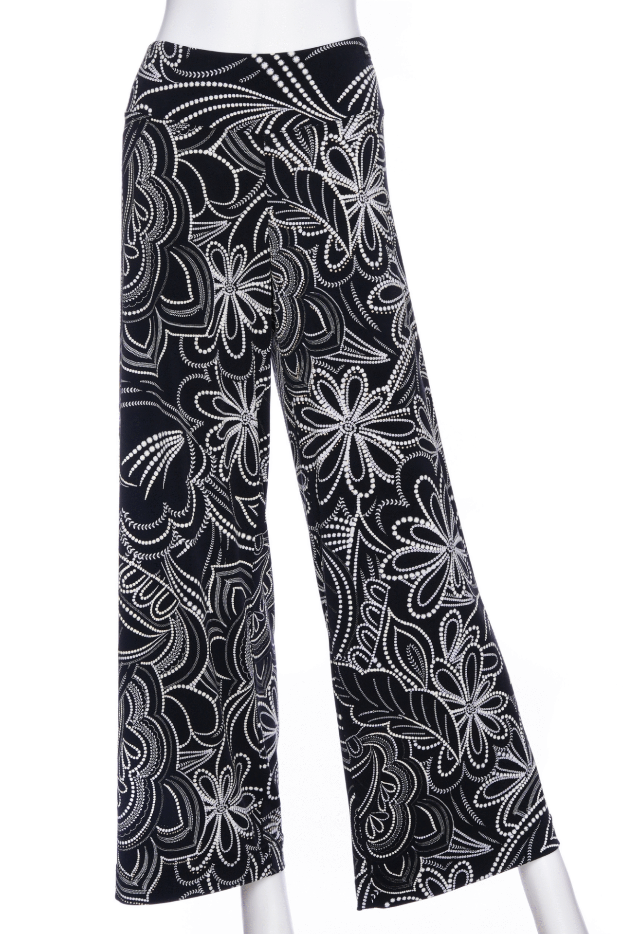 The Coco Palazzo Pants by Rien ne se Perd in Black and White floral, with a wide elastic waistband and wide legs, are shown on a mannequin against a white background. 